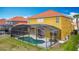 Well-maintained backyard featuring a screened-in pool, patio furniture, and a lush green lawn, perfect for relaxation at 131 Stella Pass, Davenport, FL 33837