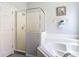 Bathroom with a glass-enclosed shower, soaking tub, and neutral decor at 131 Stella Pass, Davenport, FL 33837