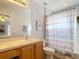 Cozy bathroom features a vanity and a bathtub with a decorative shower curtain at 131 Stella Pass, Davenport, FL 33837