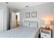 Bedroom features a double bed, nightstand, and views into another room at 131 Stella Pass, Davenport, FL 33837