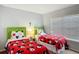 Cheerful bedroom with two twin beds, Mickey Mouse themed bedding, and window blinds at 131 Stella Pass, Davenport, FL 33837