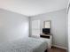 A well-lit bedroom with a double bed, dresser with television, and a window at 131 Stella Pass, Davenport, FL 33837