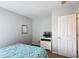 Cozy bedroom features neutral walls, simple decor, and a white dresser with a small TV at 131 Stella Pass, Davenport, FL 33837