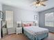 Sunlit bedroom featuring neutral walls, plush carpet, and a serene atmosphere at 131 Stella Pass, Davenport, FL 33837