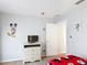 bedroom featuring a TV, Disney decor, and light gray paint at 131 Stella Pass, Davenport, FL 33837