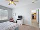 Cozy bedroom with a ceiling fan, natural light, and easy access to the kitchen at 131 Stella Pass, Davenport, FL 33837