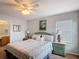 Well-lit bedroom features a comfortable bed, bedside tables, and decor for a relaxing retreat at 131 Stella Pass, Davenport, FL 33837
