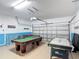 Spacious game room featuring a pool table, air hockey, and a seating area, perfect for entertaining at 131 Stella Pass, Davenport, FL 33837