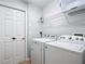 Laundry room with appliances, storage, and easy access, enhancing convenience at 131 Stella Pass, Davenport, FL 33837