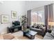 Open concept living room with backyard views, tile floors and contemporary furnishings at 131 Stella Pass, Davenport, FL 33837
