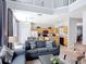 Open-concept living room with high ceilings, tile flooring, and view to the kitchen at 131 Stella Pass, Davenport, FL 33837