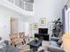 Bright living room with soaring ceilings, comfortable seating and view to the upstairs landing at 131 Stella Pass, Davenport, FL 33837
