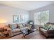 Inviting living room with neutral tones, comfortable seating, a large window, and cozy decor at 131 Stella Pass, Davenport, FL 33837