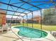 Relaxing screened-in pool with plenty of patio space for outdoor lounging and dining with views of the backyard at 131 Stella Pass, Davenport, FL 33837
