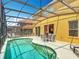 Beautiful backyard with a screened-in pool, patio seating, and a well-maintained deck, perfect for relaxation at 131 Stella Pass, Davenport, FL 33837