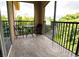 Private screened balcony with a table and chairs overlooking a lush, green landscape at 1351 Tuscan Ter # 8408, Davenport, FL 33896