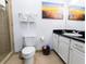 Cozy bathroom featuring a tiled shower, vanity with granite countertops, and a decorative mirror at 1351 Tuscan Ter # 8408, Davenport, FL 33896