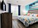 Inviting bedroom featuring bright accents, wood-look floors, and a serene tropical artwork at 1351 Tuscan Ter # 8408, Davenport, FL 33896