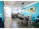 Bright dining area boasts modern lighting, stylish accents, and an open layout leading to the kitchen at 1351 Tuscan Ter # 8408, Davenport, FL 33896