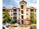 Beautiful condo building exterior featuring stucco and stone facade with private balconies and ample parking at 1351 Tuscan Ter # 8408, Davenport, FL 33896