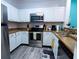 Modern kitchen with stainless steel appliances, granite countertops, and white cabinetry at 1351 Tuscan Ter # 8408, Davenport, FL 33896