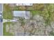 Overhead view of the home showing a big backyard with mature trees, storage shed, and off-street parking at 1518 Ohio Ave, St Cloud, FL 34769