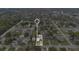 Community aerial view featuring mature trees and houses near the streets, with white boundary at 1518 Ohio Ave, St Cloud, FL 34769