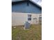 Backyard shows the exterior of the house with a modern air conditioning unit at 153 Snapdragon Ct, Kissimmee, FL 34743