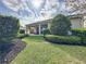 Professionally landscaped backyard featuring a covered patio for outdoor enjoyment at 16150 Parkwyn St, Winter Garden, FL 34787