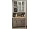 Elegant bar area with wine storage, display cabinets, granite countertops, and stylish gray cabinetry at 16150 Parkwyn St, Winter Garden, FL 34787