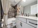 Bathroom with tub and shower featuring stylish tile, plus white sink and vanity at 16150 Parkwyn St, Winter Garden, FL 34787