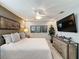 Comfortable bedroom with a ceiling fan, tv, decorative art, and a modern dresser at 16150 Parkwyn St, Winter Garden, FL 34787