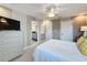 Bedroom showcasing a bed, dresser, TV, access to a bathroom and a closet at 16150 Parkwyn St, Winter Garden, FL 34787