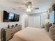 Bedroom featuring a ceiling fan, dresser, and closet at 16150 Parkwyn St, Winter Garden, FL 34787