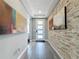 Bright entryway featuring a modern front door, tile flooring, and a decorative stone accent wall at 16150 Parkwyn St, Winter Garden, FL 34787