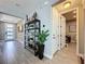 Stylish entryway featuring decorative shelving, brick accent wall and tile floors at 16150 Parkwyn St, Winter Garden, FL 34787