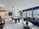 Relax in this game room featuring a pool table, sofa, and decor at 16150 Parkwyn St, Winter Garden, FL 34787