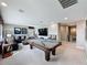 Game room with pool table, tv, seating, and modern decor at 16150 Parkwyn St, Winter Garden, FL 34787