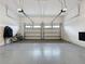 Spacious two car garage with epoxy flooring, ideal for vehicle storage and projects at 16150 Parkwyn St, Winter Garden, FL 34787