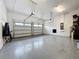 Spacious two-car garage with epoxy flooring, ample storage, and bright lighting at 16150 Parkwyn St, Winter Garden, FL 34787