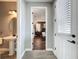 Hallway leading to a well-lit bedroom and bathroom with modern finishes and fixtures at 16150 Parkwyn St, Winter Garden, FL 34787