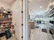 Hallway featuring a pantry and partial view of the kitchen and the open-concept layout of the home at 16150 Parkwyn St, Winter Garden, FL 34787