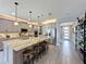 Spacious kitchen with a large center island, stainless steel appliances, pendant lighting, and modern gray cabinetry at 16150 Parkwyn St, Winter Garden, FL 34787