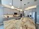 Modern kitchen with stainless steel appliances and large granite island, perfect for entertaining at 16150 Parkwyn St, Winter Garden, FL 34787