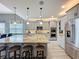Gourmet kitchen featuring stainless steel appliances, granite countertops, and a large island with seating at 16150 Parkwyn St, Winter Garden, FL 34787