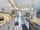 Spacious kitchen with modern grey cabinets, granite countertops, and stainless steel appliances at 16150 Parkwyn St, Winter Garden, FL 34787