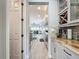 Extended view of the kitchen featuring granite countertops and wood look tile extending towards dining at 16150 Parkwyn St, Winter Garden, FL 34787