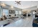 Spacious living room with gray tile flooring, ceiling fan, and lots of natural light at 16150 Parkwyn St, Winter Garden, FL 34787