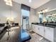Elegant bathroom with dual sinks, granite countertops, and a large framed mirror at 16150 Parkwyn St, Winter Garden, FL 34787