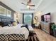 Elegant main bedroom with tray ceiling, dark wood floors, and a large window at 16150 Parkwyn St, Winter Garden, FL 34787